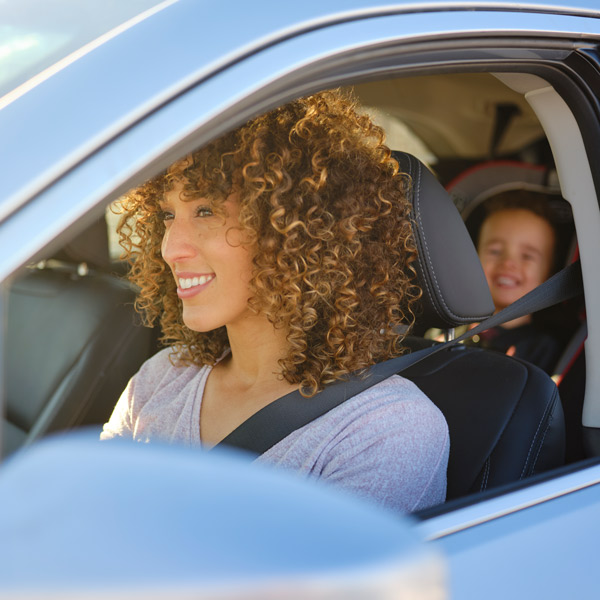 woman and child in car smiling